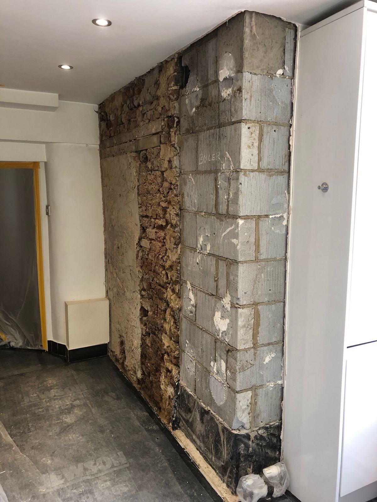 Wall stripped back to the masonry before damp proofing