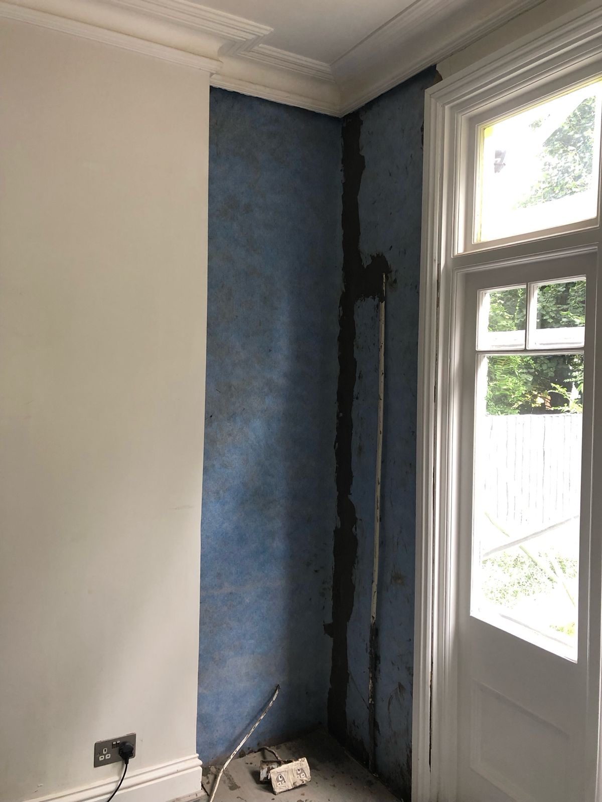 Waterproof membrane fixed to a chimney breast